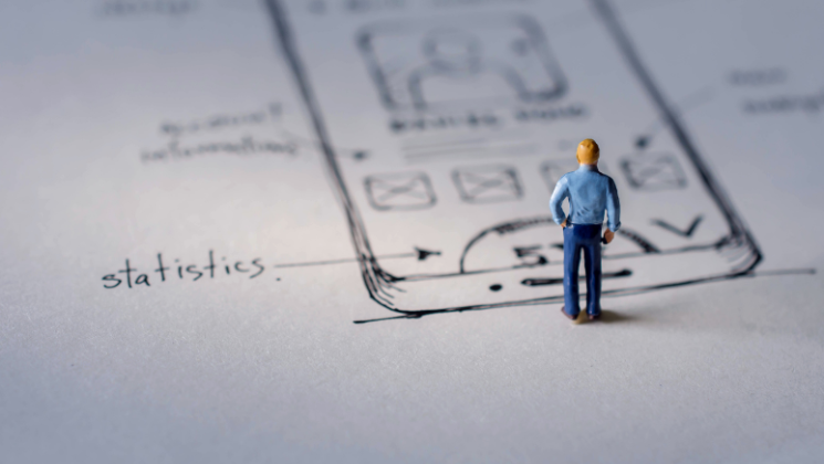 A person figure standing in front of a sketch